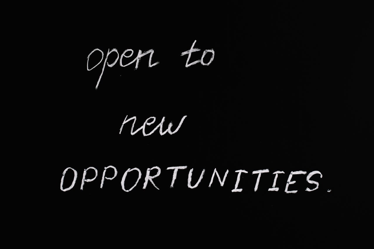 Services Blackboard with motivational quote 'Open to New Opportunities' in chalk writing.